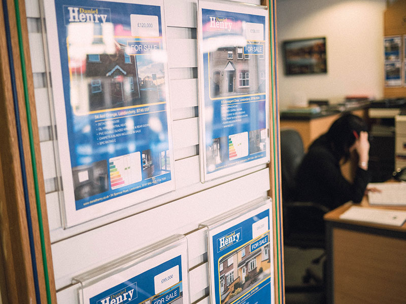 Property Brochures Displayed On Daniel Henry Estae Agents Office Interior